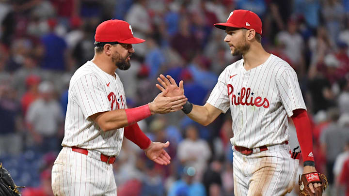 Jun 17, 2024; Philadelphia, Pennsylvania, USA; Philadelphia Phillies designated hitter Kyle Schwarber (12) and shortstop Trea Turner (7) celebrate win against the San Diego Padres at Citizens Bank Park. Mandatory Credit: Eric Hartline-Imagn Images