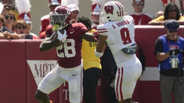 Sep 13, 2025; Tuscaloosa, Alabama, USA;  Alabama running back Kevin Riley (28) evades a tackle attempt by Wisconsin defensive back Austin Brown (9) at Saban Field at Bryant-Denny Stadium. Mandatory Credit: Gary Cosby-USA TODAY Network via Imagn Images