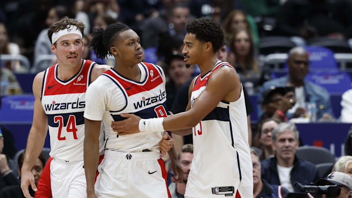 Oct 30, 2024; Washington, District of Columbia, USA; Washington Wizards guard Bub Carrington (8) is restrained by Wizards guard Jordan Poole (13) after being hard fouled by Atlanta Hawks guard Garrison Mathews (not pictured) in the first half at Capital One Arena. Mandatory Credit: Geoff Burke-Imagn Images