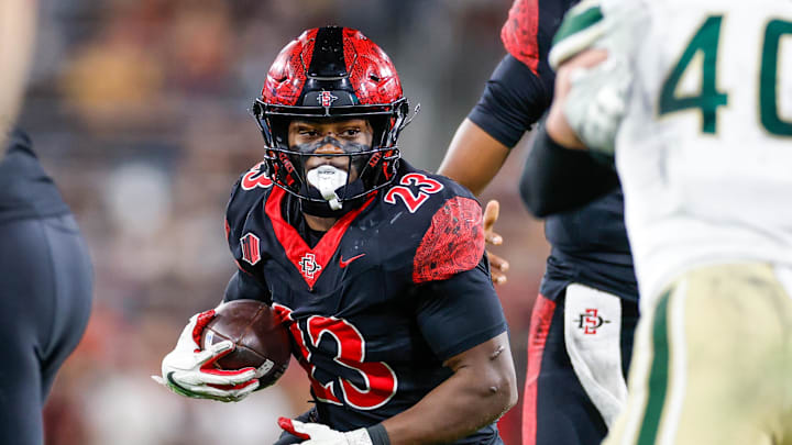 Oct 3, 2025; San Diego, California, USA; San Diego State Aztecs running back Christian Washington (23) runs the ball during the first half against the Colorado State Rams at Snapdragon Stadium.