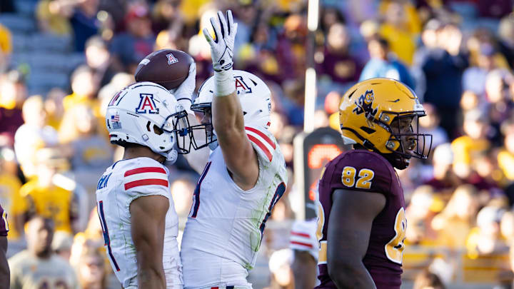 Nov 25, 2023; Tempe, Arizona, USA; Arizona Wildcats tight end Tanner McLachlan (right) celebrates a touchdown with wide receiver Tetairoa McMillan against the Arizona State Sun Devils in the second half of the Territorial Cup at Mountain America Stadium. Mandatory Credit: Mark J. Rebilas-Imagn Images