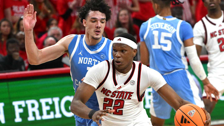 Feb 17, 2026; Raleigh, North Carolina, USA; NC State Wolfpack forward Ven-Allen Lubin (22) drives the ball to the basket against North Carolina Tar Heels forward Zayden High (1) during the first half at Lenovo Center. Mandatory Credit: Zachary Taft-Imagn Images