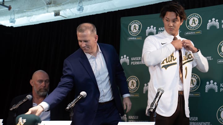 Jan 17, 2023; Oakland, CA, USA; Newly signed pitcher Shintaro Fujinami tries on his new Oakland