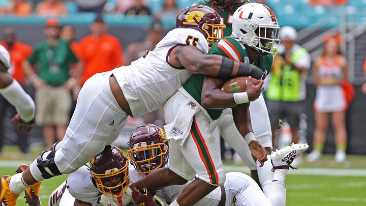 Sep 21, 2019; Miami Gardens, FL, USA; Miami Hurricanes running back DeeJay Dallas (13) carries the ball as he gets tackle by Central Michigan Chippewas defensive lineman D'Andre Dill (55) during the first quarter of a football game at Hard Rock Stadium. Mandatory Credit: Sam Navarro-USA TODAY Sports