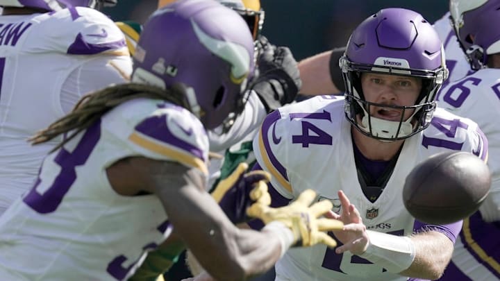 Minnesota Vikings quarterback Sam Darnold (14) pitches the ball to running back Aaron Jones (33) during the third quarter of their game Sunday, Sept. 29, 2024, at Lambeau Field in Green Bay, Wis. Minnesota Vikings quarterback Sam Darnold (14) pitches the ball to running back Aaron Jones (33) during the third quarter of their game Sunday, Sept. 29, 2024, at Lambeau Field in Green Bay, Wis.