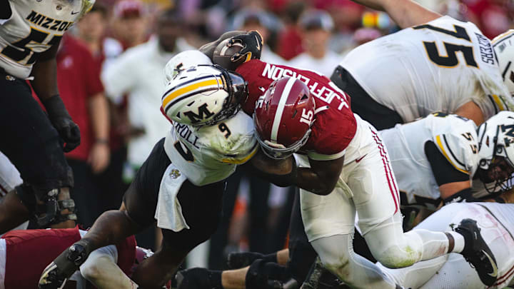 Oct 26, 2024; Tuscaloosa, Alabama, USA;  Alabama Crimson Tide linebacker Justin Jefferson (15) brings down Missouri Tigers running back Marcus Carroll (9) during the fourth quarter at Bryant-Denny Stadium. Mandatory Credit: Will McLelland-Imagn Images