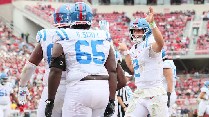 Nov 2, 2024; Fayetteville, Arkansas, USA; Ole Miss Rebels defensive tackle JJ Pegues (89) celebrates with quarterback Jaxson Dart (2) after scoring a rushing touchdown in the third quarter against the Arkansas Razorbacks at Donald W. Reynolds Razorback Stadium. Mississippi won 63-31. Mandatory Credit: Nelson Chenault-Imagn Images Nov 2, 2024; Fayetteville, Arkansas, USA; Ole Miss Rebels defensive tackle JJ Pegues (89) celebrates with quarterback Jaxson Dart (2) after scoring a rushing touchdown in the third quarter against the Arkansas Razorbacks at Donald W. Reynolds Razorback Stadium. Mississippi won 63-31. Mandatory Credit: Nelson Chenault-Imagn Images