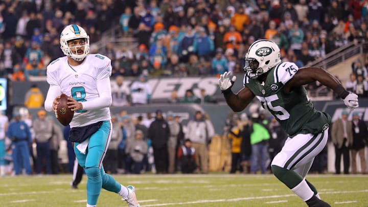 Miami Dolphins quarterback Matt Moore (8) looks to pass against New York Jets defensive tackle Anthony Johnson (75) during the second quarter at MetLife Stadium in a 2016 game.