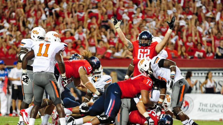 Sept. 8, 2012; Tucson, AZ, USA; Arizona Wildcats running back Ka'Deem Carey (25) breaks into the endzone for a 1 yard touchdown as offensive linesman Chris Putton (62) celebrates  during the first half against the Oklahoma State Cowboys at Arizona Stadium. Mandatory Credit: Matt Kartozian-USA TODAY Sports