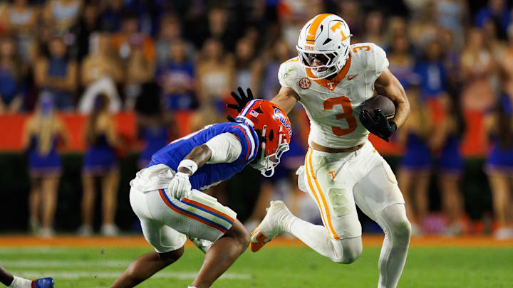 Nov 22, 2025; Gainesville, Florida, USA; Tennessee Volunteers tight end Jack van Dorselaer (3) stiff arms Florida Gators defensive back Sharif Denson (0) during the second half at Ben Hill Griffin Stadium. Mandatory Credit: Matt Pendleton-Imagn Images