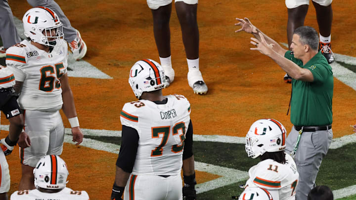 Jan 19, 2026; Miami Gardens, FL, USA; Miami Hurricanes head coach Mario Cristobal speaks to his players during warmups prior to the College Football Playoff National Championship game against the Indiana Hoosiers at Hard Rock Stadium. Mandatory Credit: Kim Klement Neitzel-Imagn Images