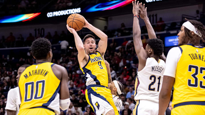 Nov 1, 2024; New Orleans, Louisiana, USA;  Indiana Pacers guard T.J. McConnell (9) passes the ball to Indiana Pacers guard Bennedict Mathurin (00) against New Orleans Pelicans forward Zion Williamson (1) during the second half at Smoothie King Center. Mandatory Credit: Stephen Lew-Imagn Images