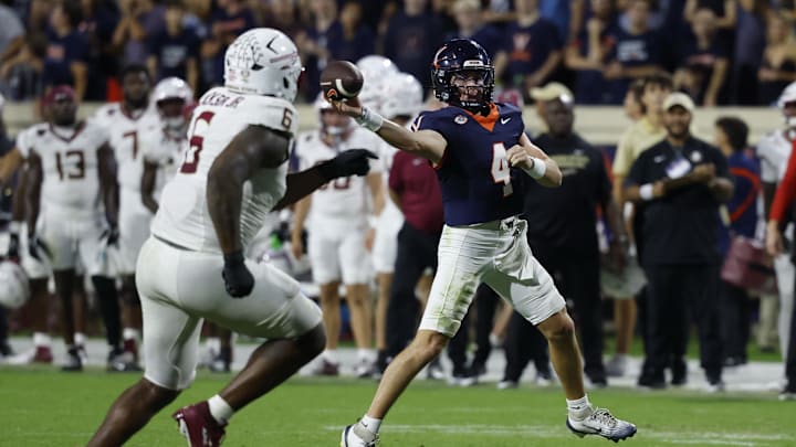 Sep 26, 2025; Charlottesville, Virginia, USA; Virginia Cavaliers quarterback Chandler Morris (4) passes the ball as Florida State Seminoles defensive lineman Darrell Jackson Jr. (6) chases in the first overtime period at Scott Stadium. Mandatory Credit: Geoff Burke-Imagn Images