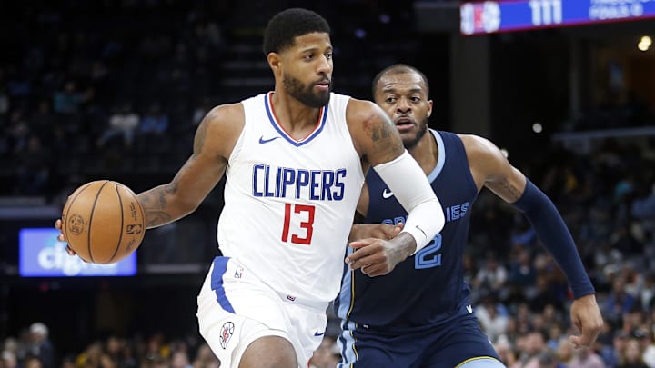 Jan 12, 2024; Memphis, Tennessee, USA; Los Angeles Clippers forward Paul George (13) drives to the basket as Memphis Grizzlies forward Xavier Tillman (2) defends during the second half at FedExForum. Mandatory Credit: Petre Thomas-Imagn Images