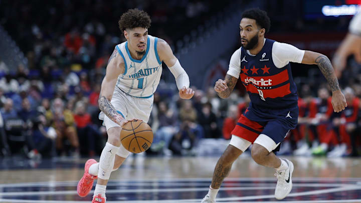 Dec 26, 2024; Washington, District of Columbia, USA; Charlotte Hornets guard LaMelo Ball (1) drives to the basket as Washington Wizards forward Justin Champagnie (9) chases in the first quarter at Capital One Arena. Mandatory Credit: Geoff Burke-Imagn Images