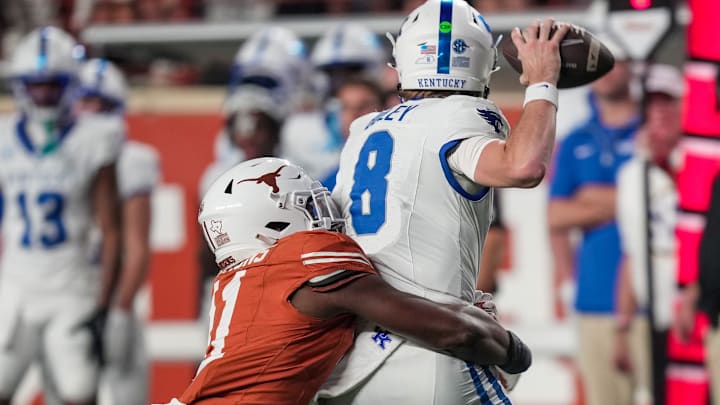 Texas Longhorns linebacker Colin Simmons (11) tries to sack Kentucky Wildcats quarterback Cutter Boley (8) in the fourth quarter during the second half of an NCAA college football game at Darrell K Royal Texas Memorial Stadium, Austin, Texas, Saturday, Nov 24, 2024.