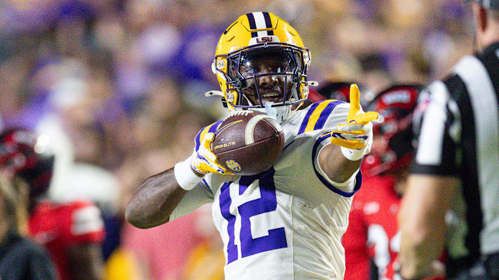 Nov 22, 2025; Baton Rouge, Louisiana, USA;  LSU Tigers wide receiver Kyle Parker (12) reacts to making a first down against Western Kentucky Hilltoppers defensive back Nazir Ward (not pictured) during the first half at Tiger Stadium. Mandatory Credit: Stephen Lew-Imagn Images