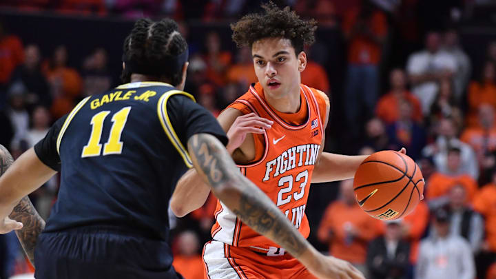 Feb 27, 2026; Champaign, Illinois, USA;  Illinois Fighting Illini guard Keaton Wagler (23) drives the ball against Michigan Wolverines guard Roddy Gayle Jr. (11) during the first half at State Farm Center. Mandatory Credit: Ron Johnson-Imagn Images