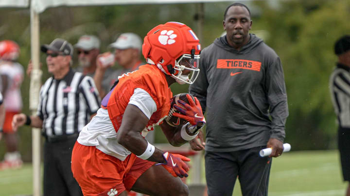 Clemson running backs coach C.J. Spiller watches running back Adam Randall (8) with the ball during Clemson football 2025 practice at the Allen N. Reeves Football Complex in Clemson, S.C. Friday, August 1, 2025.
