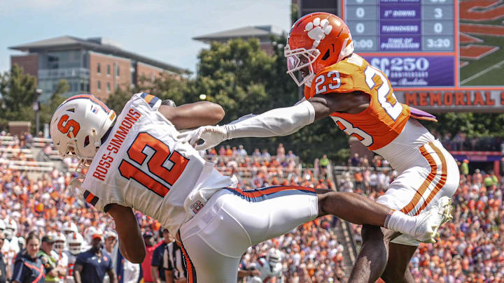 Sep 20, 2025; Clemson, South Carolina, USA; Syracuse Orange wide receiver Justus Ross-Simmons (12) catches a touchdown near Clemson Tigers cornerback Ashton Hampton (23) during the first quarter at Memorial Stadium. Mandatory Credit: Ken Ruinard/GREENVILLE NEWS-USA TODAY Network via Imagn Images