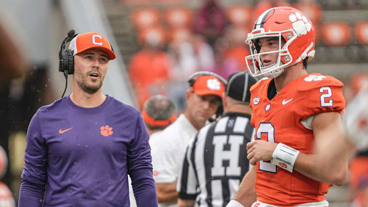 Clemson offensive coordinator Garrett Riley talks with quarterback Cade Klubnik (2) during at timeout in the second quarter at Memorial Stadium in Clemson, S.C. Saturday, September 6, 2025.