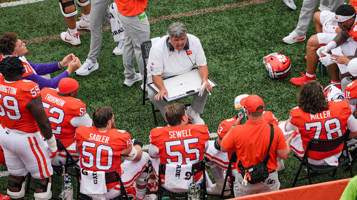 Clemson offensive line coach Matt Luke talks to linemen after three-and-out series with Troy during the first quarter at Memorial Stadium in Clemson, S.C. Saturday, September 6, 2025.