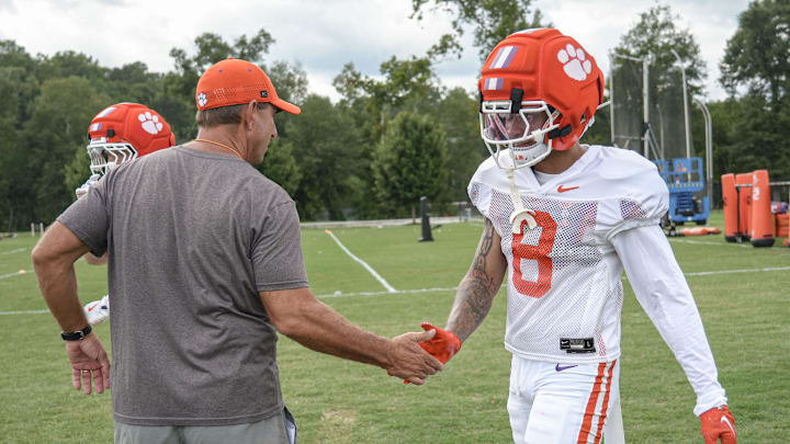 Clemson head coach Dabo Swinney greets cornerback Avieon Terrell (8) during Clemson football 2025 practice at Jervey Meadows in Clemson, S.C. Wednesday, August 6, 2025.