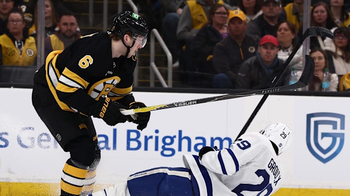 Mar 24, 2026; Boston, Massachusetts, USA; Boston Bruins defenseman Mason Lohrei (6) knocks down Toronto Maple Leafs center Bo Groulx (29) during the first period at TD Garden. Mandatory Credit: Winslow Townson-Imagn Images