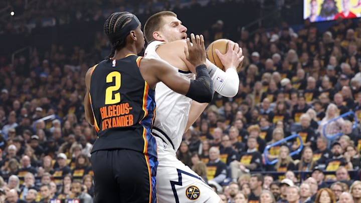 May 5, 2025; Oklahoma City, Oklahoma, USA; Denver Nuggets center Nikola Jokic (15) drives against Oklahoma City Thunder guard Shai Gilgeous-Alexander (2) during the first quarter in game one of the second round for the 2025 NBA Playoffs at Paycom Center. Mandatory Credit: Alonzo Adams-Imagn Images May 5, 2025; Oklahoma City, Oklahoma, USA; Denver Nuggets center Nikola Jokic (15) drives against Oklahoma City Thunder guard Shai Gilgeous-Alexander (2) during the first quarter in game one of the second round for the 2025 NBA Playoffs at Paycom Center. Mandatory Credit: Alonzo Adams-Imagn Images