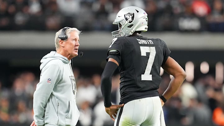 Nov 23, 2025; Paradise, Nevada, USA; Las Vegas Raiders quarterback Geno Smith (7) talks to head coach Pete Carroll in game against the Cleveland Browns during the fourth quarter at Allegiant Stadium. Mandatory Credit: Stephen R. Sylvanie-Imagn Images
