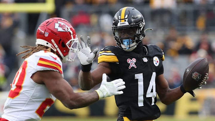 Pittsburgh Steelers wide receiver George Pickens (14) runs after a catch as Kansas City Chiefs safety Justin Reid (20) defends during the fourth quarter  at Acrisure Stadium. 