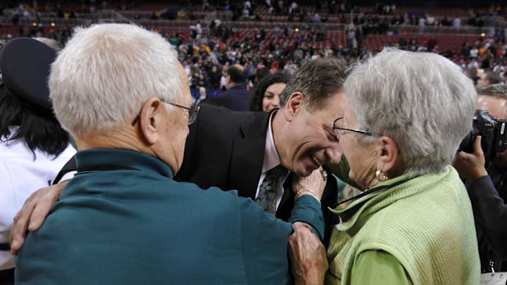 Michigan State Spartans head coach Tom Izzo is greeted by his mother and father. (2010).