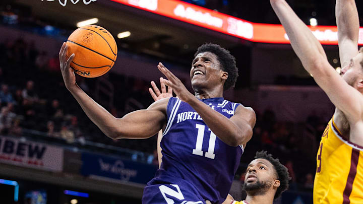 Mar 12, 2025; Indianapolis, IN, USA; Northwestern Wildcats guard Jordan Clayton (11)  shoots the ball while  Minnesota Golden Gophers guard Femi Odukale (11) defends in the first half at Gainbridge Fieldhouse. Mandatory Credit: Trevor Ruszkowski-Imagn Images