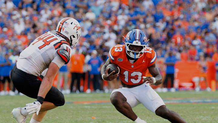 Sep 12, 2026; Gainesville, Florida, USA;  Florida Gators running back Jadan Baugh (13) runs the ball against Campbell Fighting Camels linebacker Landon Sargent (44) during the first half at Ben Hill Griffin Stadium.  Mandatory Credit: Matt Pendleton-Imagn Images