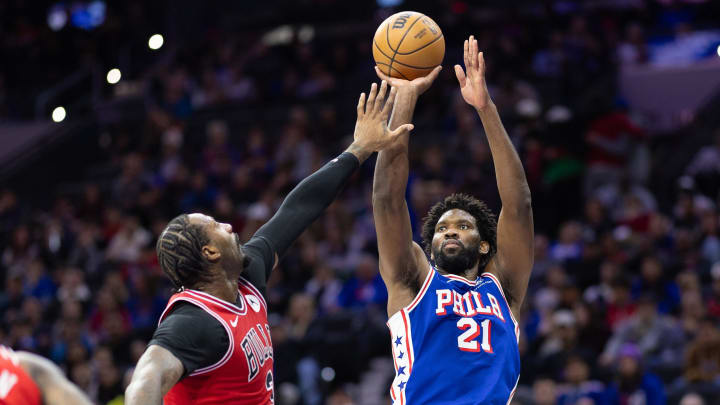 Jan 2, 2024; Philadelphia, Pennsylvania, USA; Philadelphia 76ers center Joel Embiid (21) shoots the ball past Chicago Bulls center Andre Drummond (3) during the second quarter at Wells Fargo Center. Mandatory Credit: Bill Streicher-USA TODAY Sports