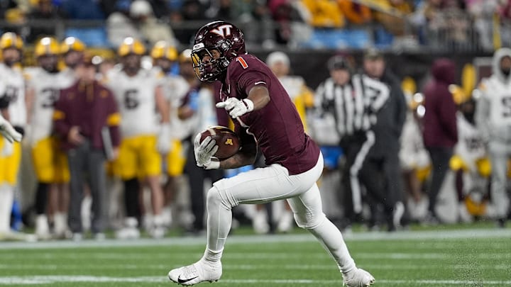 Jan 3, 2025; Charlotte, NC, USA; Virginia Tech Hokies cornerback Dante Lovett (1)  runs after his interception against the Minnesota Golden Gophers during the second half at the Duke’s Mayo Bowl at Bank of America Stadium. Mandatory Credit: Jim Dedmon-Imagn Images