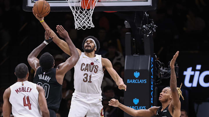 Mar 1, 2026; Brooklyn, New York, USA;  Cleveland Cavaliers center Jarrett Allen (31) puts up a reverse layup past Brooklyn Nets center Day'ron Sharpe (20) in the third quarter at Barclays Center. Mandatory Credit: Wendell Cruz-Imagn Images