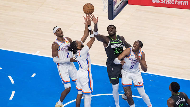 May 20, 2025; Oklahoma City, Oklahoma, USA; Oklahoma City Thunder guard Isaiah Joe (11) shoots against Minnesota Timberwolves forward Julius Randle (30) in the second quarter during game one of the western conference finals for the 2025 NBA Playoffs at Paycom Center. Mandatory Credit: Brett Rojo-Imagn Images