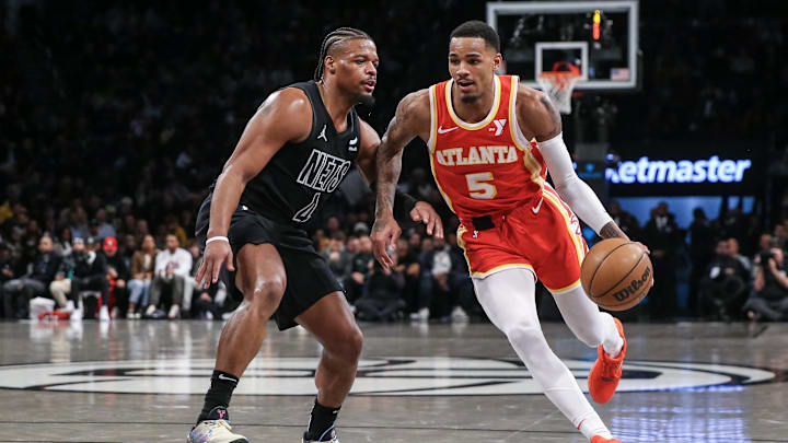 Feb 29, 2024; Brooklyn, New York, USA;  Atlanta Hawks guard Dejounte Murray (5) moves past Brooklyn Nets guard Dennis Smith Jr. (4) in the fourth quarter at Barclays Center. Mandatory Credit: Wendell Cruz-USA TODAY Sports