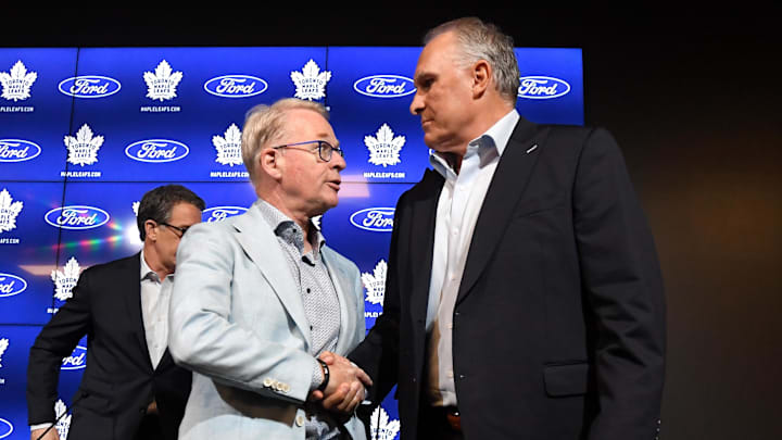 May 21, 2024; Toronto, Ontario, CANADA;  Maple Leaf Sport and Entertainment president Keith Pelley (left) shakes hands with newly appointed Toronto Maple Leafs head coach Craig Berube after an introductory media conference at Ford Performance Centre. Mandatory Credit: Dan Hamilton-Imagn Images