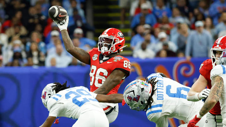 Jan 1, 2026; New Orleans, LA, USA; Georgia Bulldogs wide receiver Dillon Bell (86) passes the ball defended by Mississippi Rebels safety Nick Cull (29) and linebacker TJ Dottery (6) in the third quarter during the 2026 Sugar Bowl and quarterfinal game of the College Football Playoff at Caesars Superdome. Mandatory Credit: Amber Searls-Imagn Images Jan 1, 2026; New Orleans, LA, USA; Georgia Bulldogs wide receiver Dillon Bell (86) passes the ball defended by Mississippi Rebels safety Nick Cull (29) and linebacker TJ Dottery (6) in the third quarter during the 2026 Sugar Bowl and quarterfinal game of the College Football Playoff at Caesars Superdome. Mandatory Credit: Amber Searls-Imagn Images