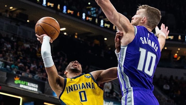 Feb 3, 2023; Indianapolis, Indiana, USA; Indiana Pacers guard Tyrese Haliburton (0) shoots the ball while Sacramento Kings forward Domantas Sabonis (10) defends in the second quarter at Gainbridge Fieldhouse. Mandatory Credit: Trevor Ruszkowski-Imagn Images