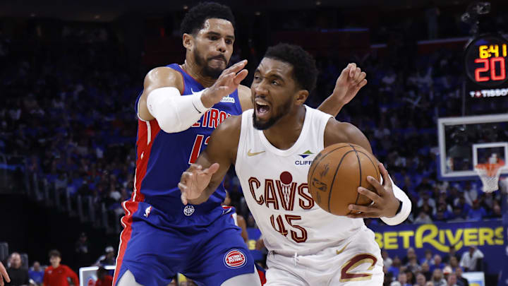 May 13, 2026; Detroit, Michigan, USA; Cleveland Cavaliers guard Donovan Mitchell (45) is defended by Detroit Pistons forward Tobias Harris (12) in the first half during game five of the second round of the 2026 NBA Playoffs at Little Caesars Arena. Mandatory Credit: Rick Osentoski-Imagn Images
