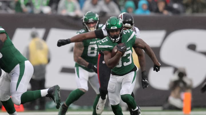 Dec 3, 2023; East Rutherford, New Jersey, USA; New York Jets running back Dalvin Cook (33) runs with the ball against the Atlanta Falcons during the first quarter at MetLife Stadium. Dec 3, 2023; East Rutherford, New Jersey, USA; New York Jets running back Dalvin Cook (33) runs with the ball against the Atlanta Falcons during the first quarter at MetLife Stadium.