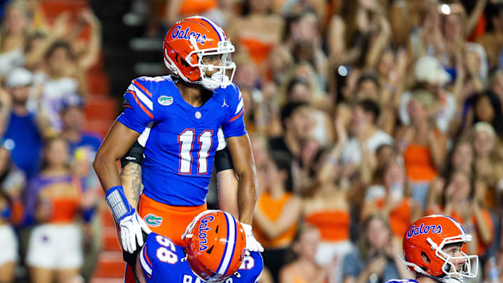 Florida Gators wide receiver Aidan Mizell (11) is lifted in the air by Florida Gators offensive lineman Austin Barber (58) after his touchdown pass to make it 24-7 over Samford at Ben Hill Griffin Stadium in Gainesville, FL on Saturday, September 7, 2024 against the Samford Bulldogs. The Florida Gators won 45-7 over the Bulldogs. [Doug Engle/Gainesville Sun]
