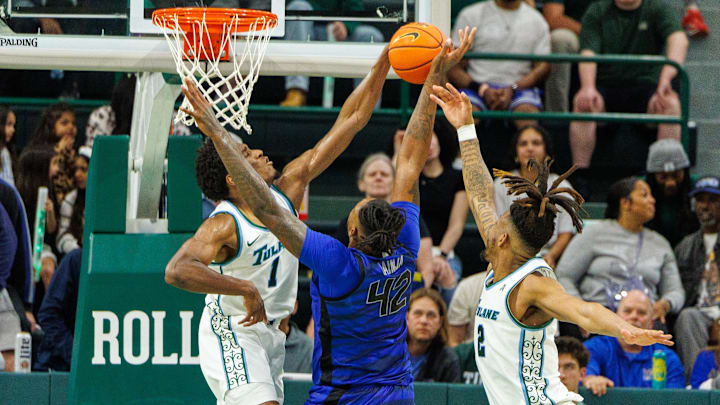 Jan 30, 2025; New Orleans, Louisiana, USA;  Memphis Tigers forward Dain Dainja (42) has a shot blocked by Tulane Green Wave forward Kaleb Banks (1) during the second half at Avron B. Fogelman Arena in Devlin Fieldhouse.
