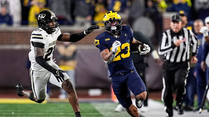 Michigan running back Jordan Marshall (23) runs against Purdue defensive back Tahj Ra-El (21) during the second half at Michigan Stadium in Ann Arbor on Saturday, November 1, 2025.