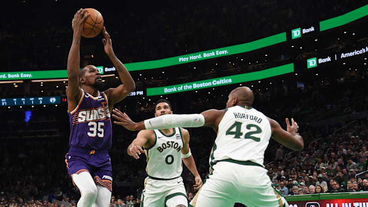 Mar 14, 2024; Boston, Massachusetts, USA;  Phoenix Suns forward Kevin Durant (35) drives to the basket while Boston Celtics center Al Horford (42) defends during the first half at TD Garden. Mandatory Credit: Bob DeChiara-Imagn Images