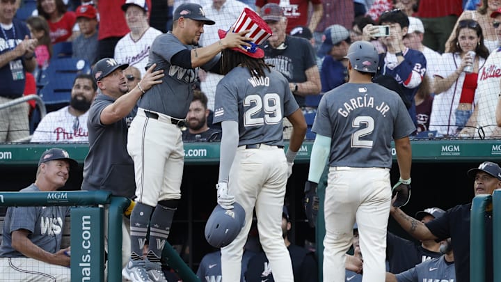 Sep 28, 2024; Washington, District of Columbia, USA; Washington Nationals second base Ildemaro Vargas (14) leaps to put the Home Run Hat on Nationals outfielder James Wood (29) after a two run home run against the Philadelphia Phillies during the sixth inning at Nationals Park. Mandatory Credit: Geoff Burke-Imagn Images