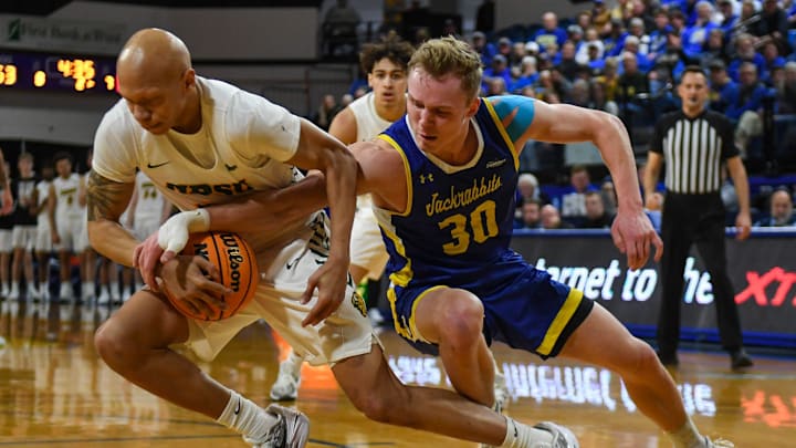SDSU s guard Charlie Easley (30) attempts to take the ball from NDSU s guard Jacari White (11) during the second half on Thursday, Feb. 1, 2024 at Frost Arena in Brookings, South Dakota. SDSU s guard Charlie Easley (30) attempts to take the ball from NDSU s guard Jacari White (11) during the second half on Thursday, Feb. 1, 2024 at Frost Arena in Brookings, South Dakota.